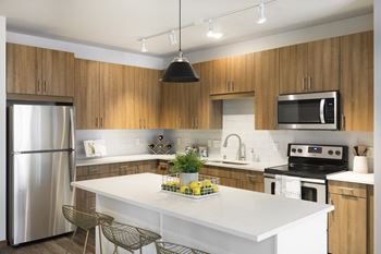 a kitchen with stainless steel appliances and a white counter top